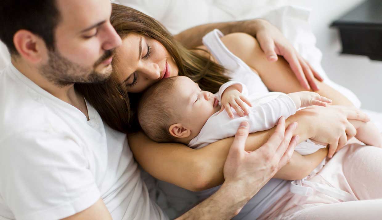 Mother and Father with sleeping baby