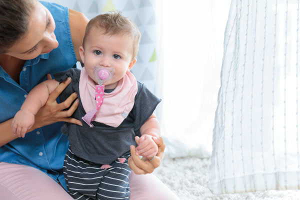 Baby with Chicco Pink Paci Clip and Pacifier