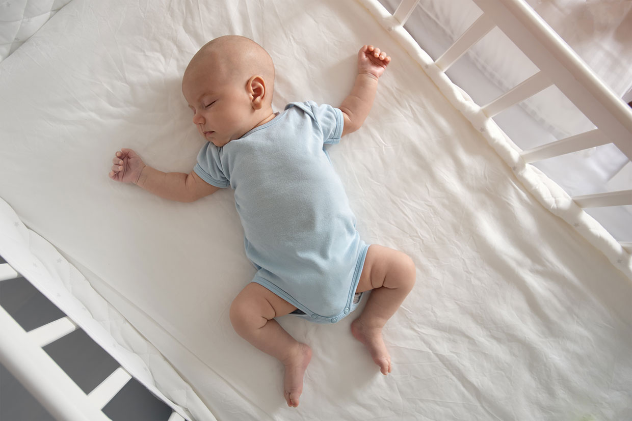 Baby sleeping in crib image