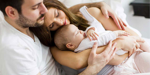 Mother and Father with sleeping baby